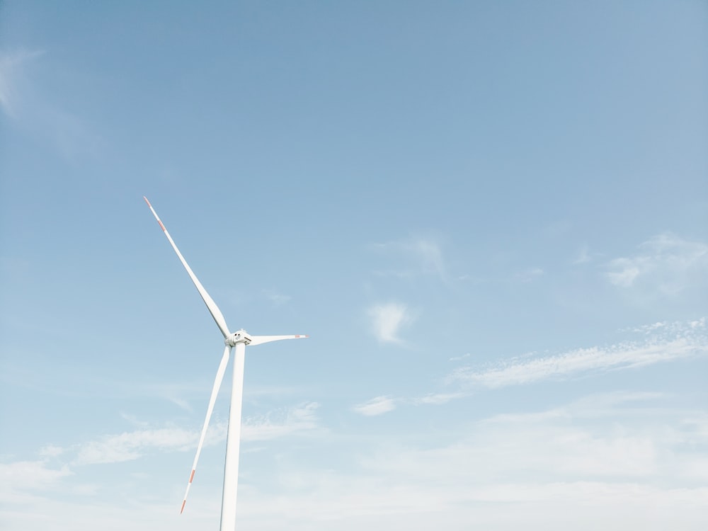 wind mill under blue sky and white clouds during daytime