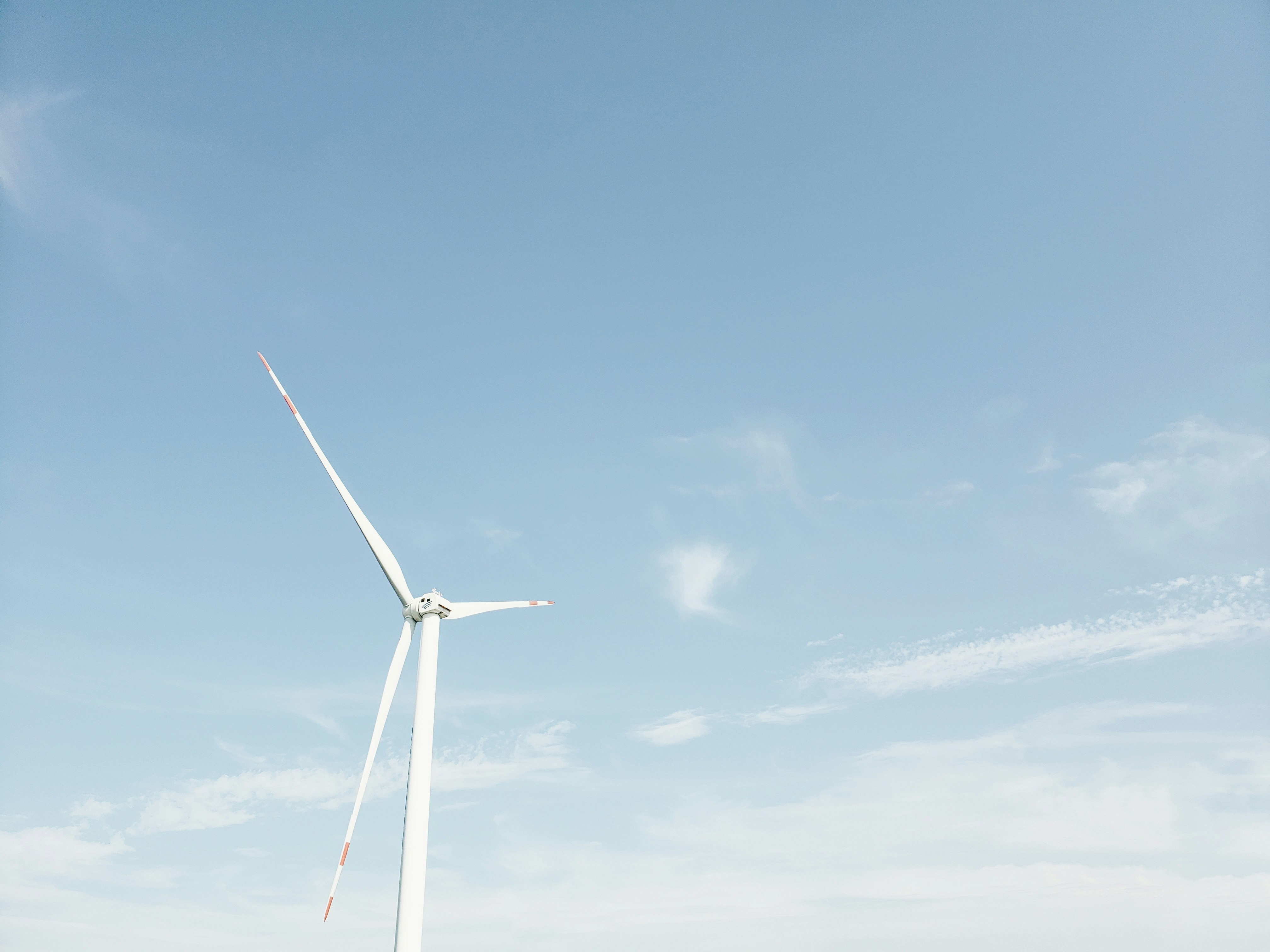 wind mill under blue sky and white clouds during daytime