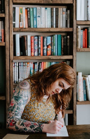 woman writing on white paper
