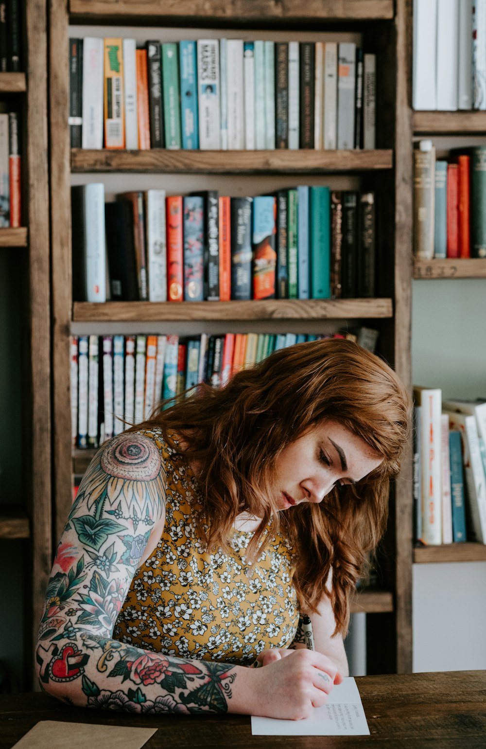 woman writing on white paper