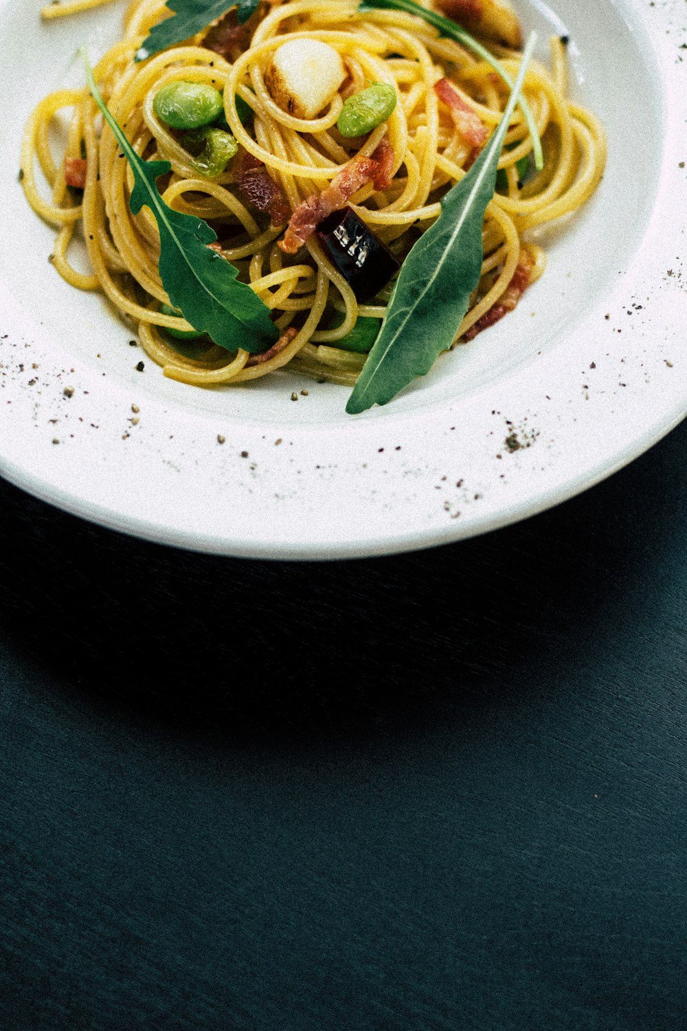 cooked noodles on white ceramic bowl