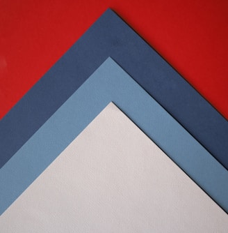 a close up of three different colors of paper