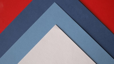 a close up of three different colors of paper