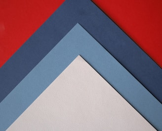 a close up of three different colors of paper