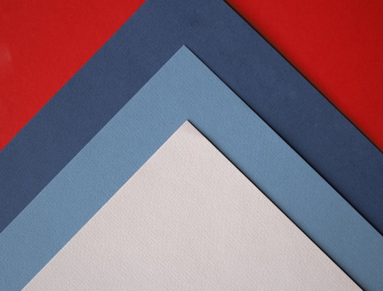 a close up of three different colors of paper