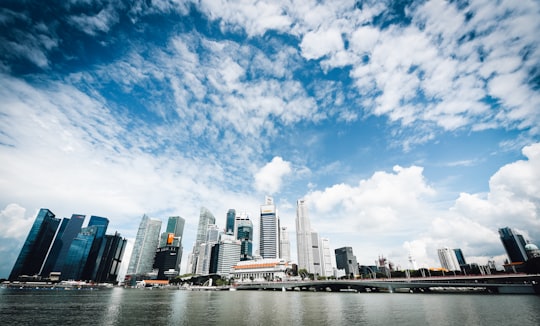 low-angle photography of building beside body of water during daytime in Marina Bay Singapore