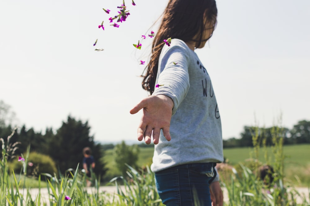 girl on green grass field at daytime