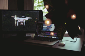 Clean workspace with laptop showing automation workflow on screen