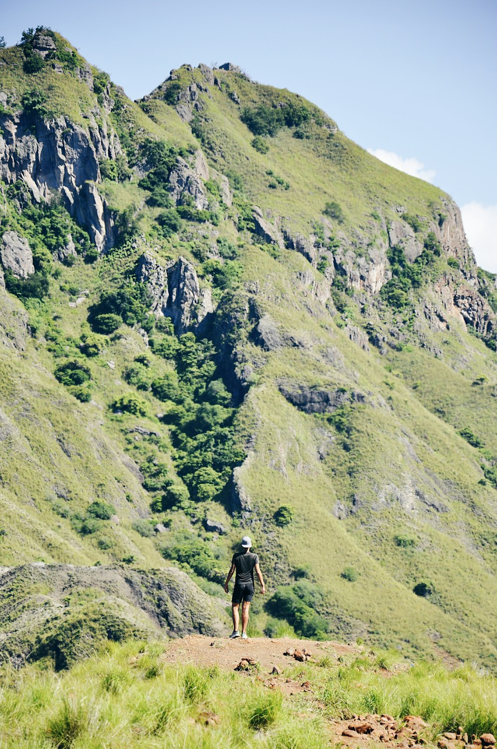 photo of person standing in front of rock formations