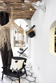 black wooden armchair with white throw pillow