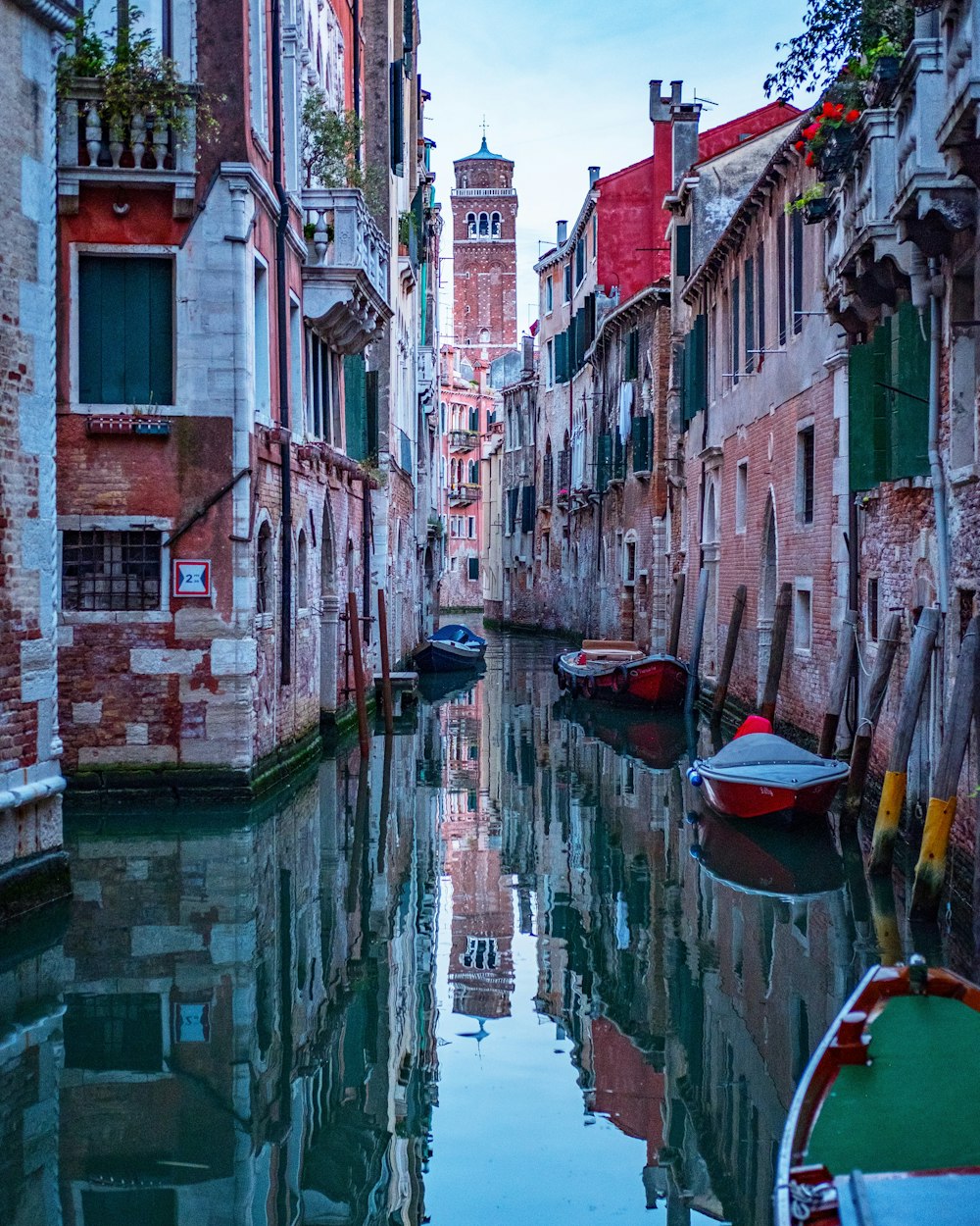 boats docked near brown buildings