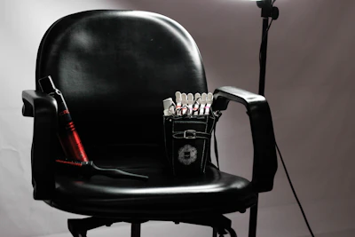 A cozy, softly lit in-home beauty setup featuring hair styling tools and a welcoming chair.