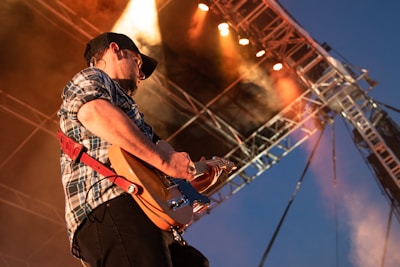person playing guitar on stage