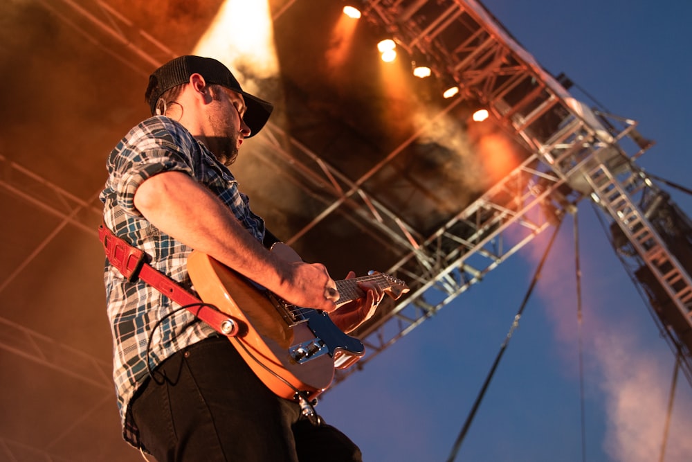 person playing guitar on stage