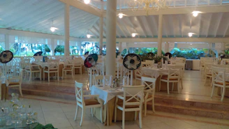 A cozy, sunlit dining area with happy guests enjoying Salvadoran dishes.
