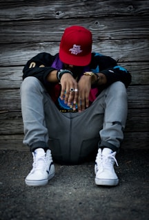man wearing grey pants and white low-top sneakers