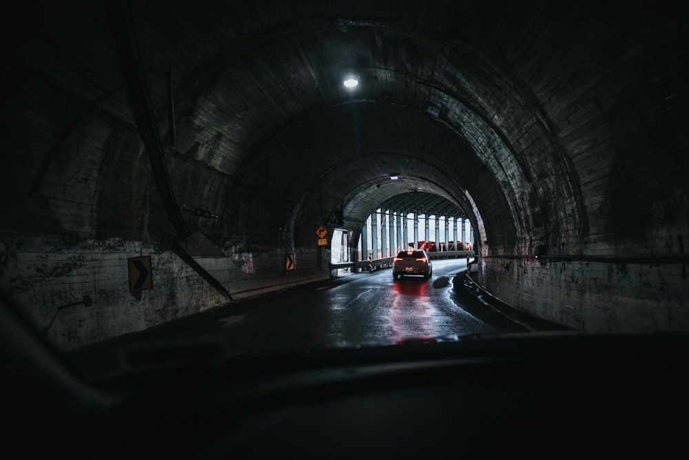 car under tunnel during daytime