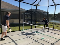 A group of players sharing tips and encouragement during a friendly pickleball match.