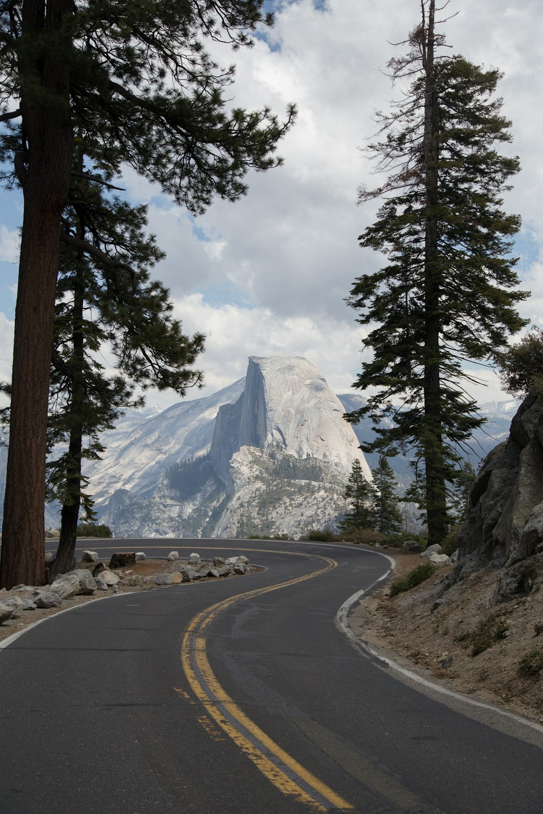 snow covered mountain in front of road during daytime