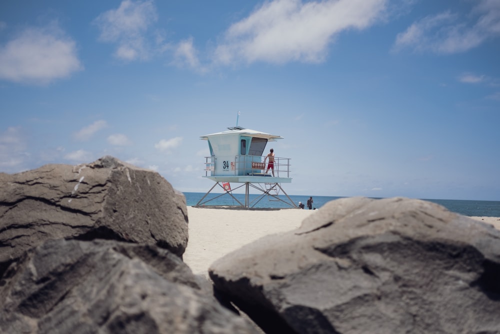 person standing on lifeguard tower