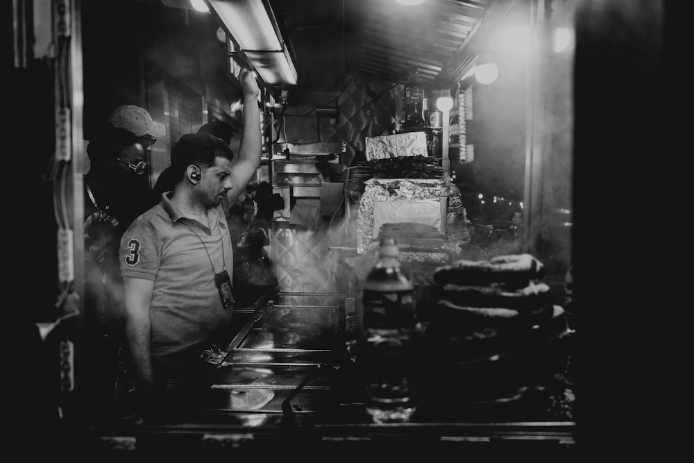 grayscale photo of standing man