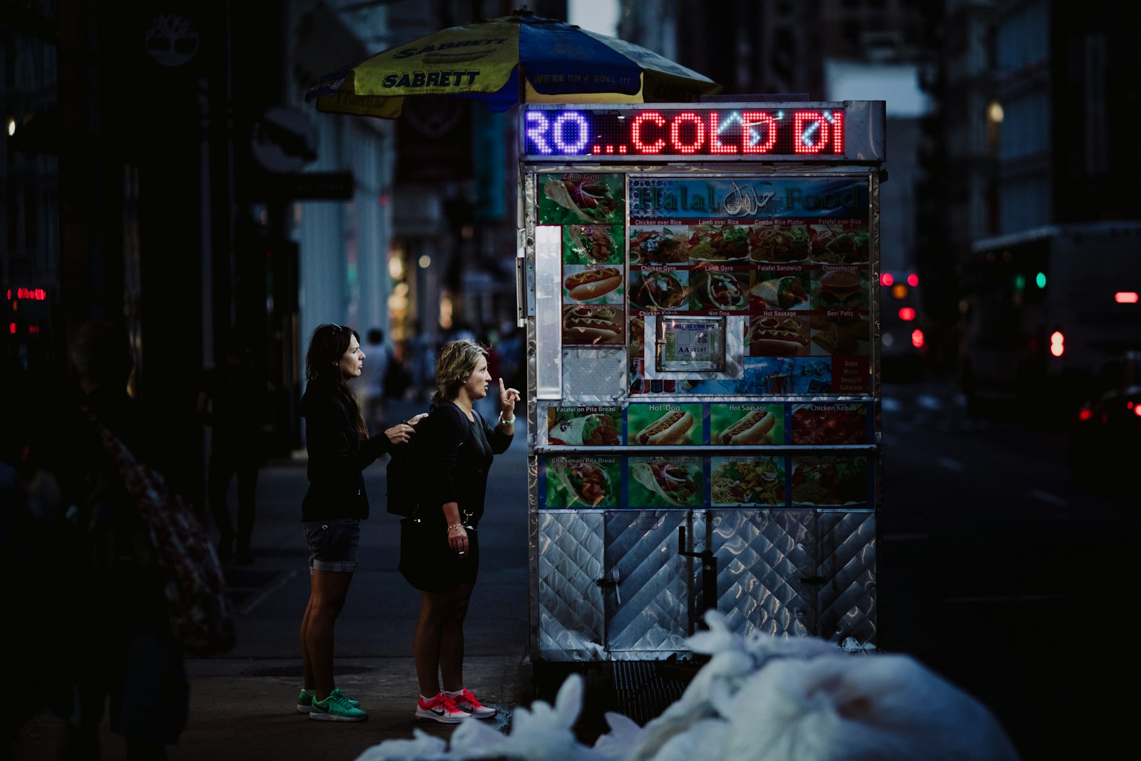 Canon EOS 5D Mark IV + Canon EF 135mm F2L USM sample photo. Two woman buying food photography