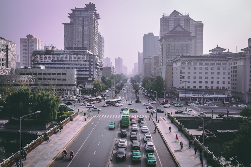 vehicles on road and high-rise buildings photo