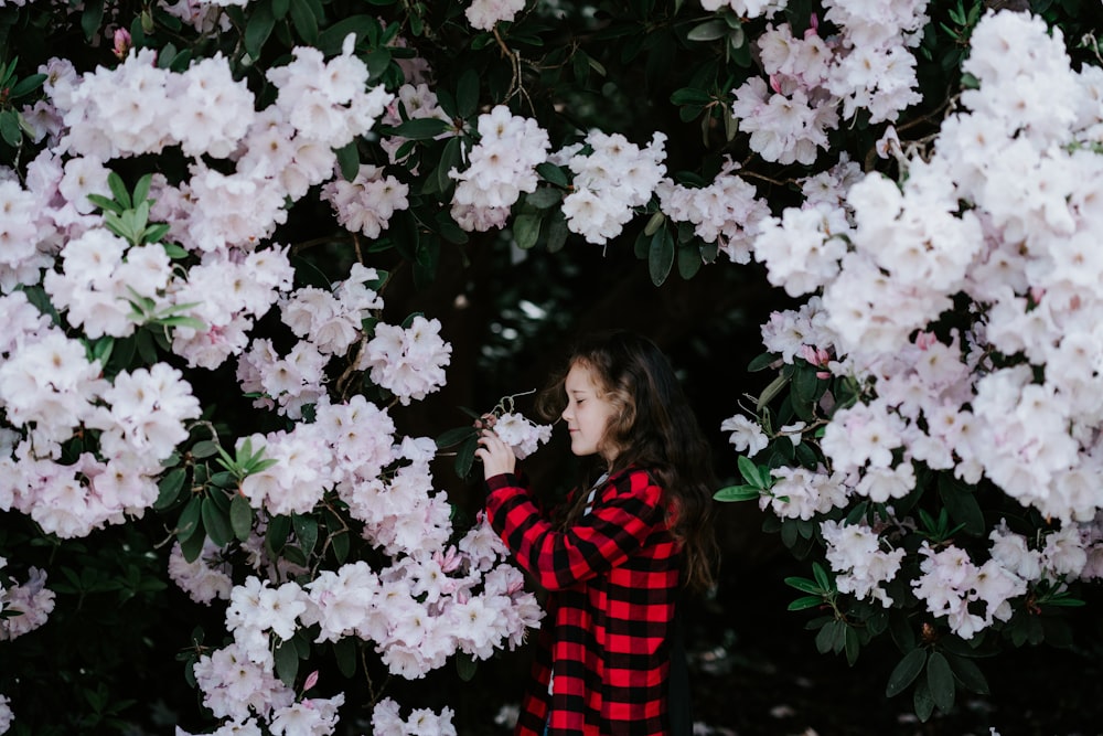 girl holding white flower covered with flower