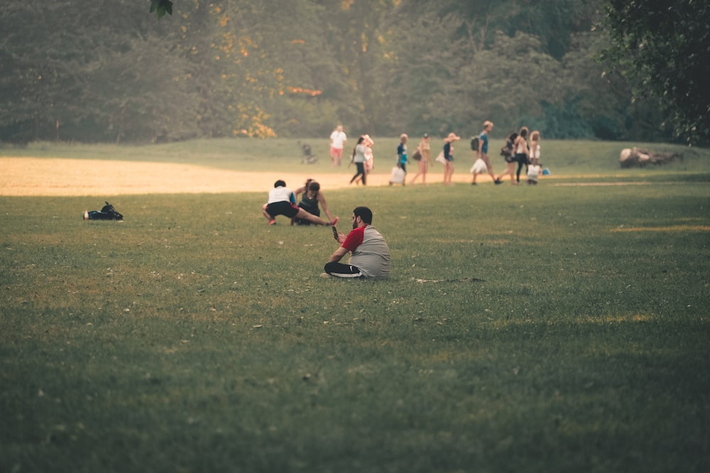 people on green grass field