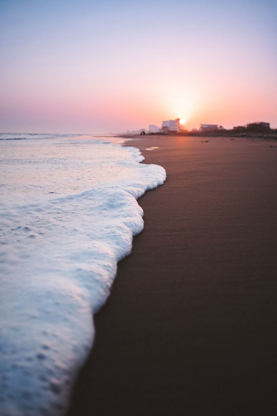 waves on brown sand closeup photography during sunset in Mazandaran Province Iran