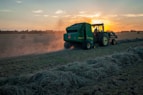 green farm heavy equipment on green field