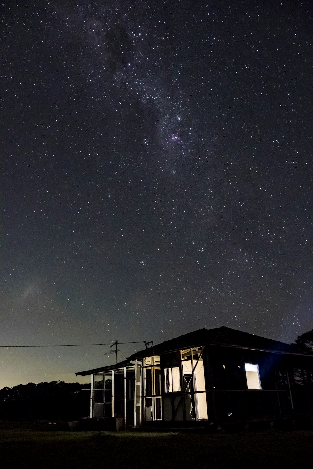 wooden house under starry sky