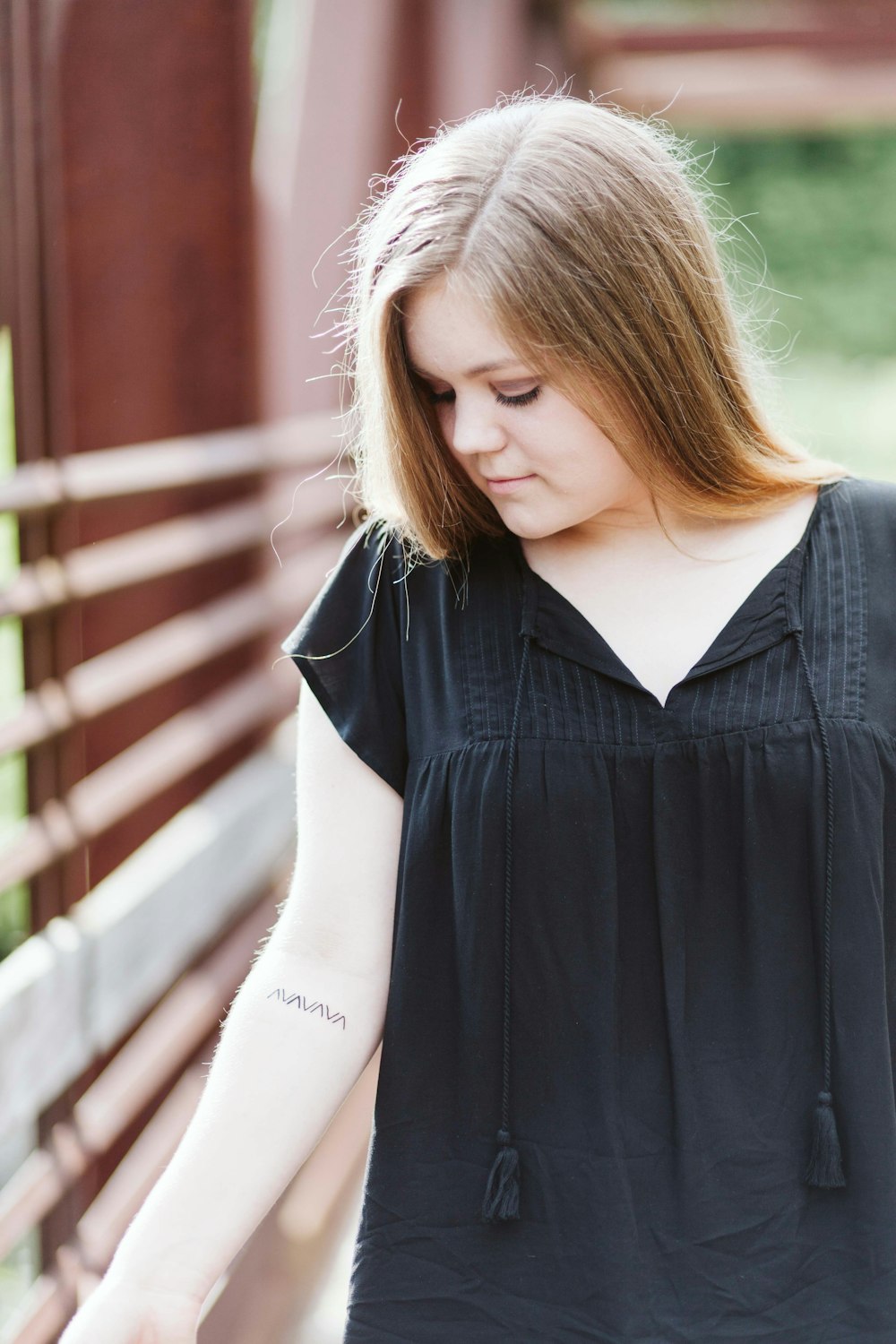 selective focus photography of woman on bridge