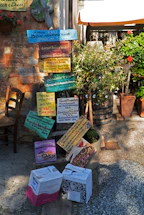 A friendly chef handing a colorful menu to a smiling community member outdoors