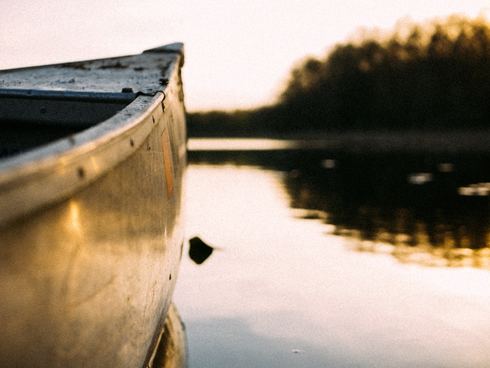 gray canoe on body of water