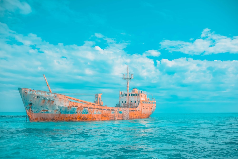 brown and gray cargo ship on body of water