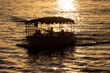 Elegant small group aboard a luxury boat, framed by warm golden sunset hues.