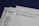 Documents are laid out on a surface, with the largest sheet displaying the text 'Petition to File for Bankruptcy'. Several forms and paperwork are visible underneath, suggesting a formal or legal context.