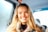 smiling woman sitting in vehicle