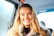 smiling woman sitting in vehicle