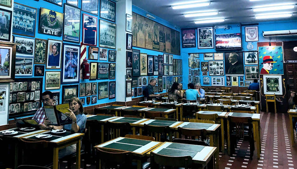 Cozy Scandinavian-style restaurant interior with warm lighting and deep blue accents.