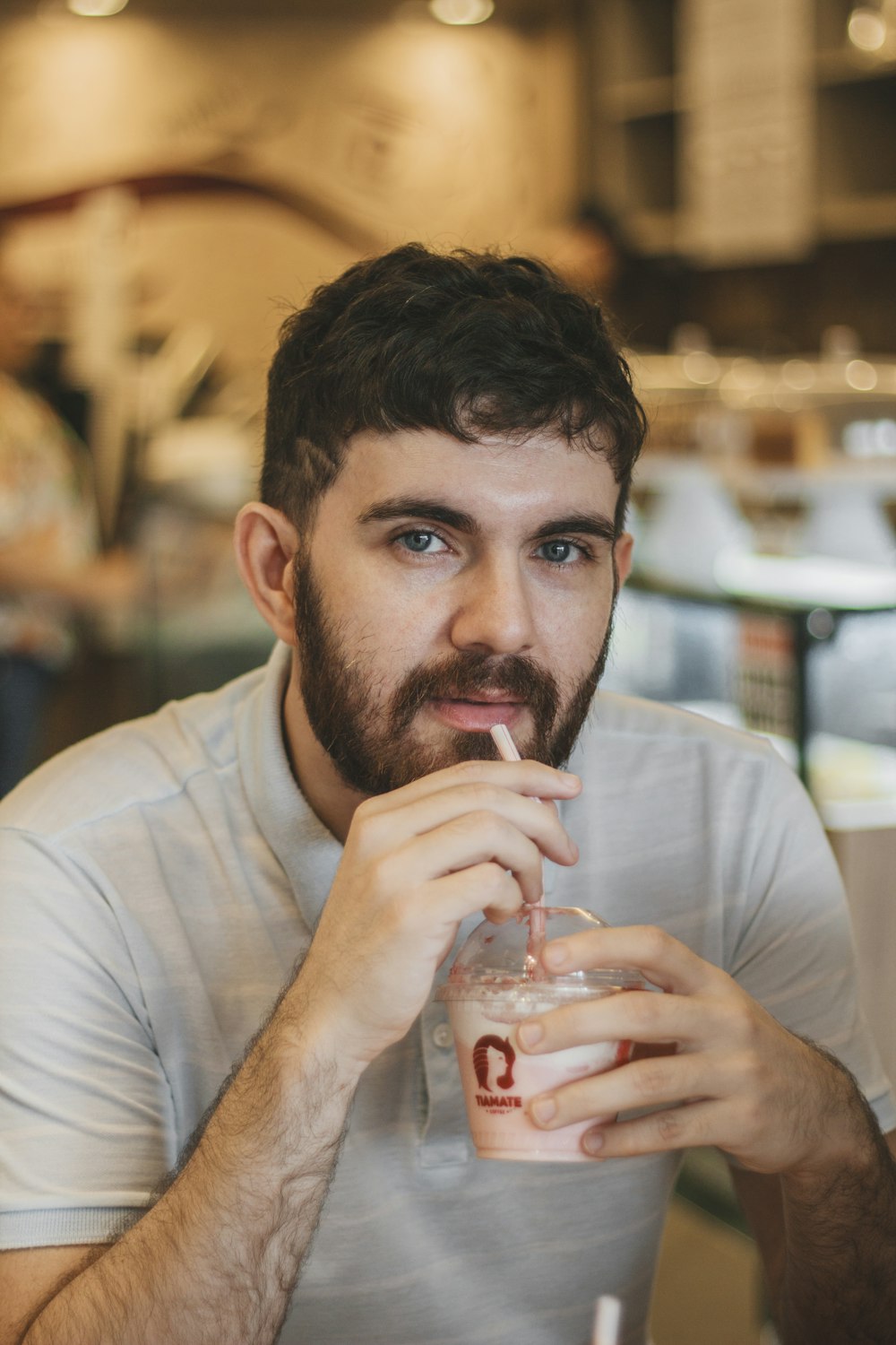 selective focus photography of man drinking smoothie