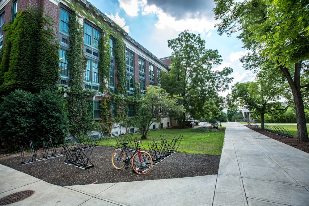 black bicycle parked in front of building