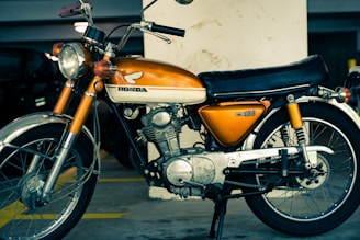 orange and black Honda standard motorcycle