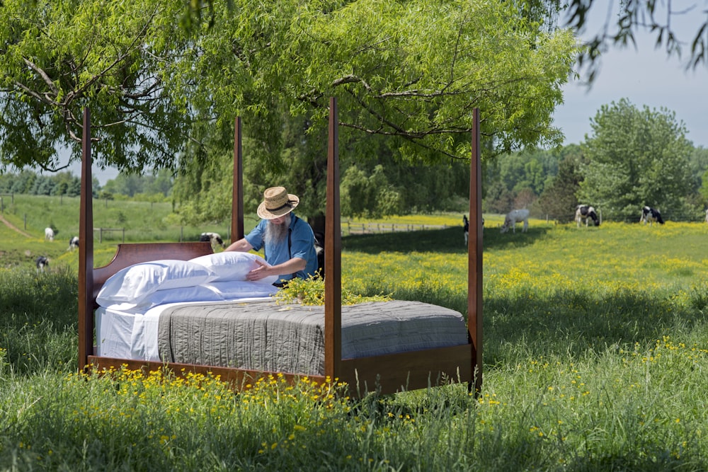 brown wooden canopy bed on green grass during daytime