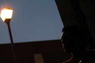 Evening city skyline with a model silhouetted wearing Lumina Apparel outerwear