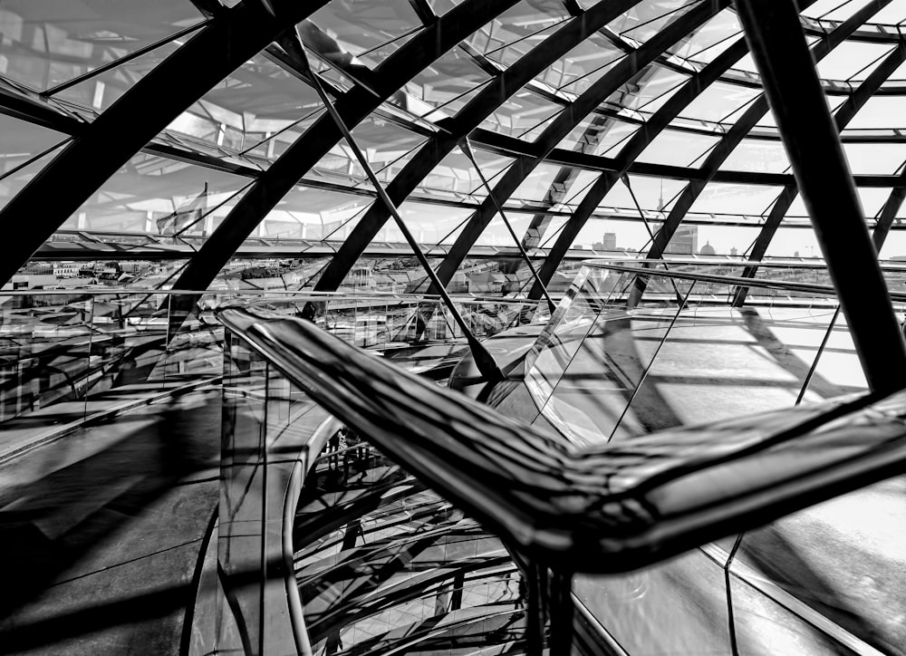 a black and white photo of a glass building