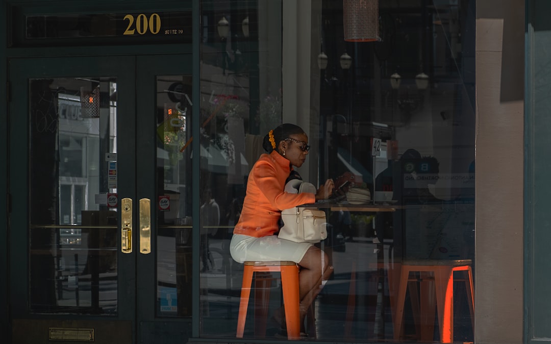 woman sitting in front of brown table