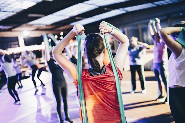Person exercising with resistance bands in a bright home gym