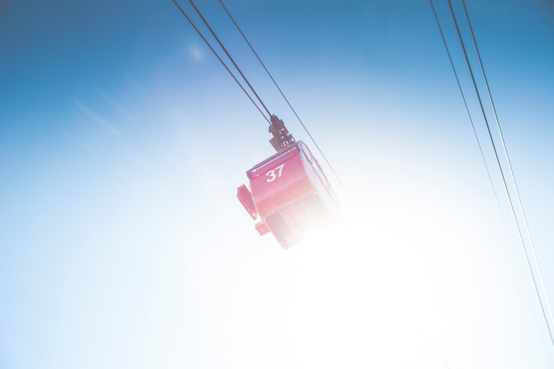 red cable car under clear sky